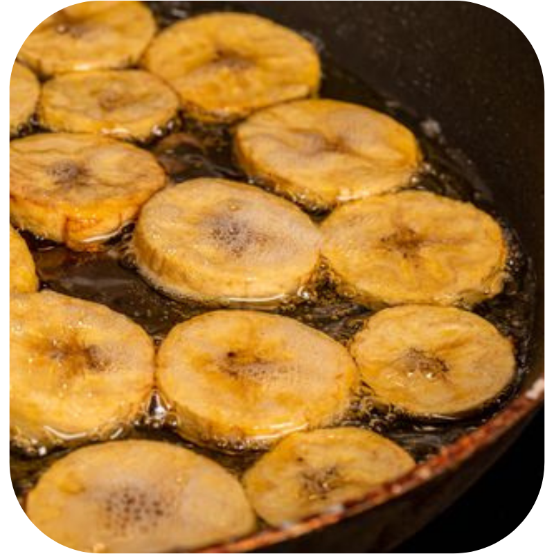 photograph of plantains frying in oil